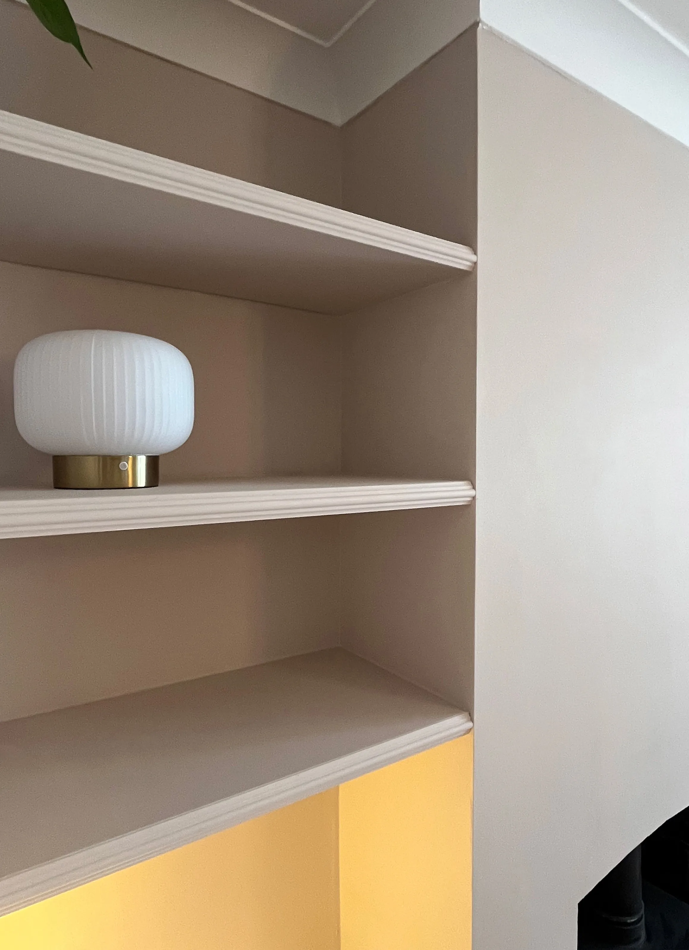 Close up view of floating shelves featuring astragal moulding on the front edge