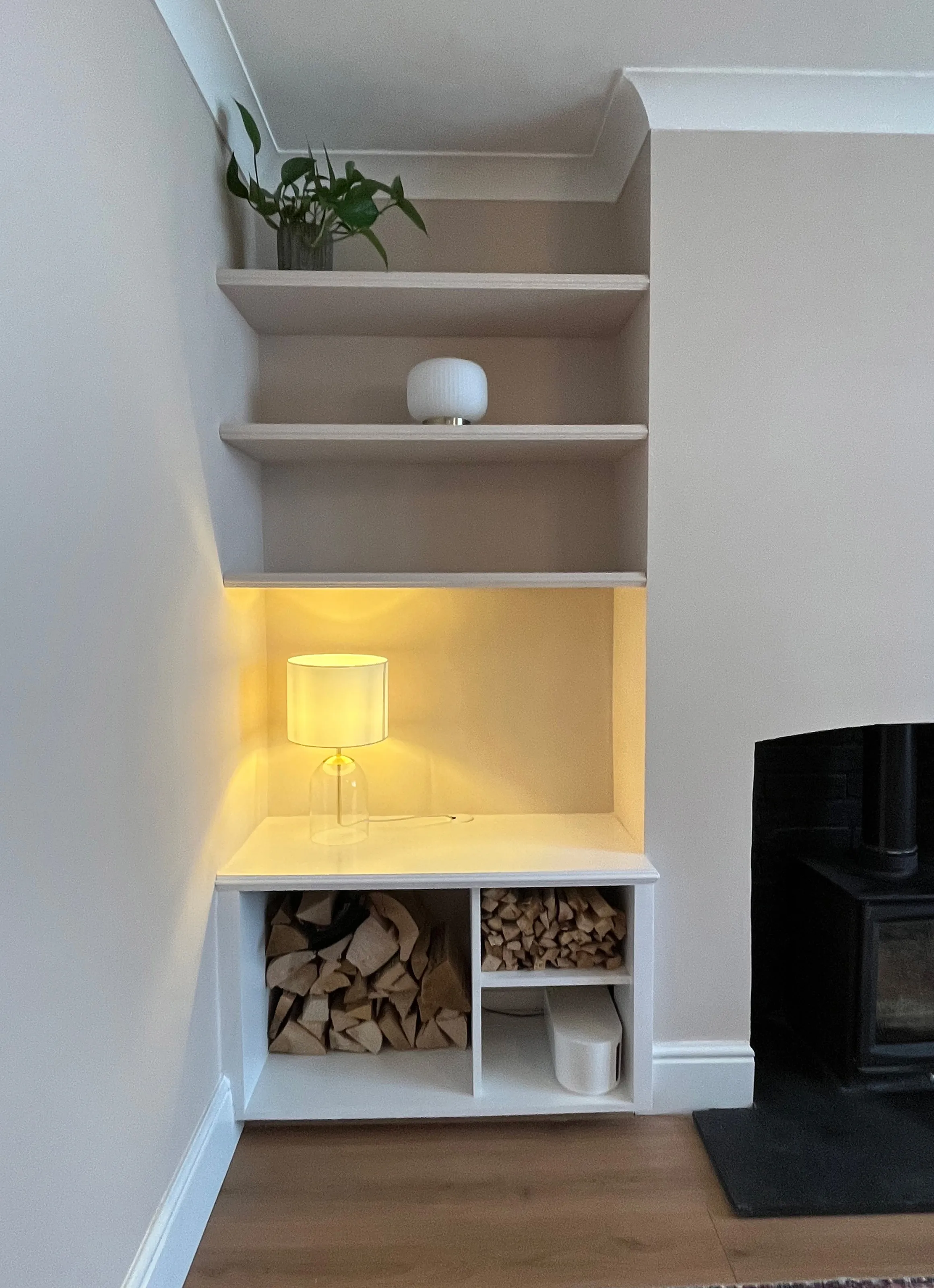 Front view of a left hand Victorian style alcove unit showing the three floating shelves and log store