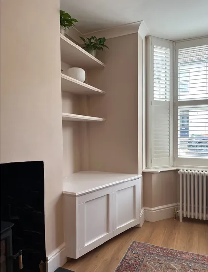 Alcove with floating shelves and storage cabinet