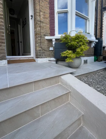 Newly paved front garden with planters