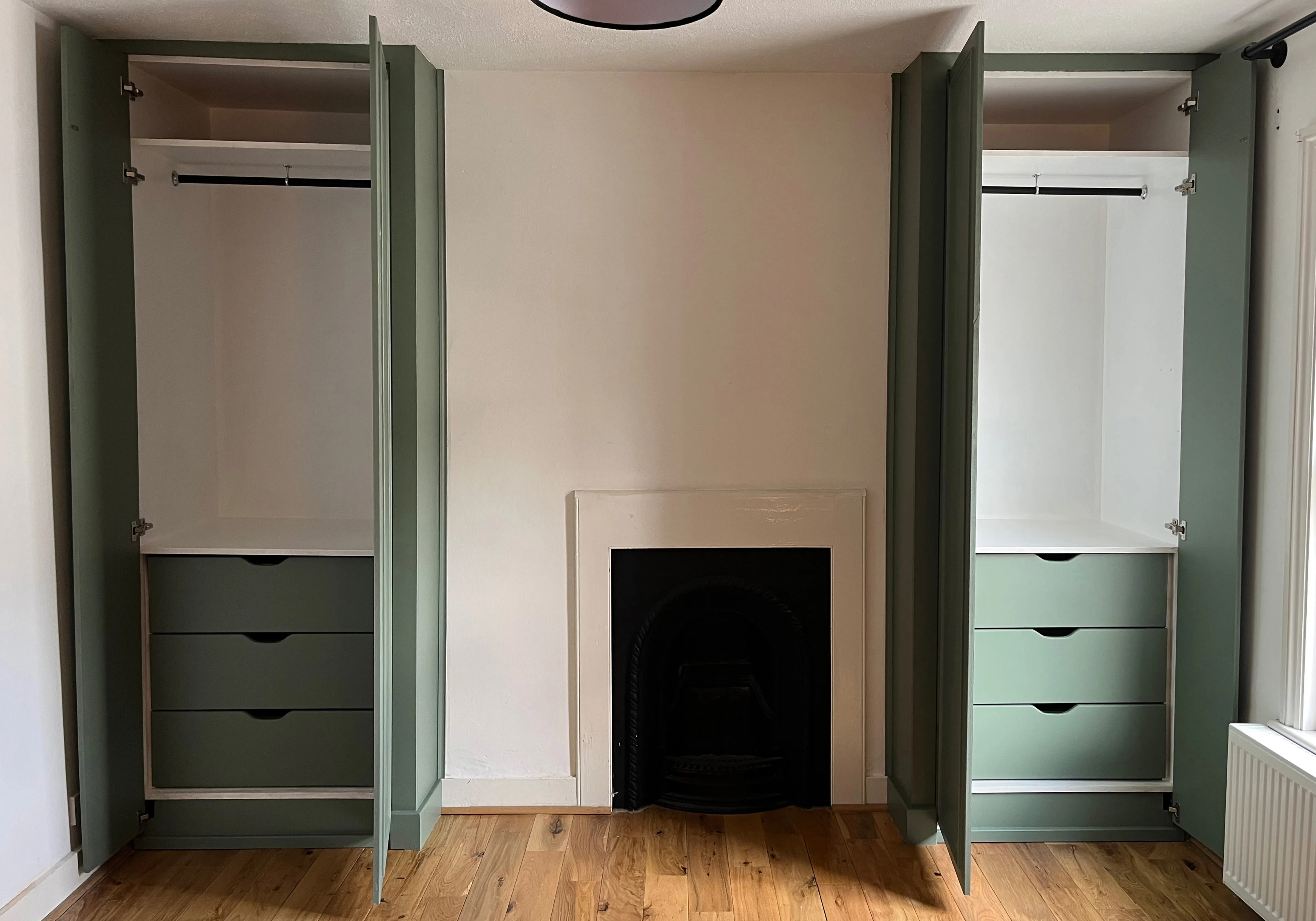 Pair of bespoke fitted wardrobes either side of a chimney breast in a Blackheath bedroom