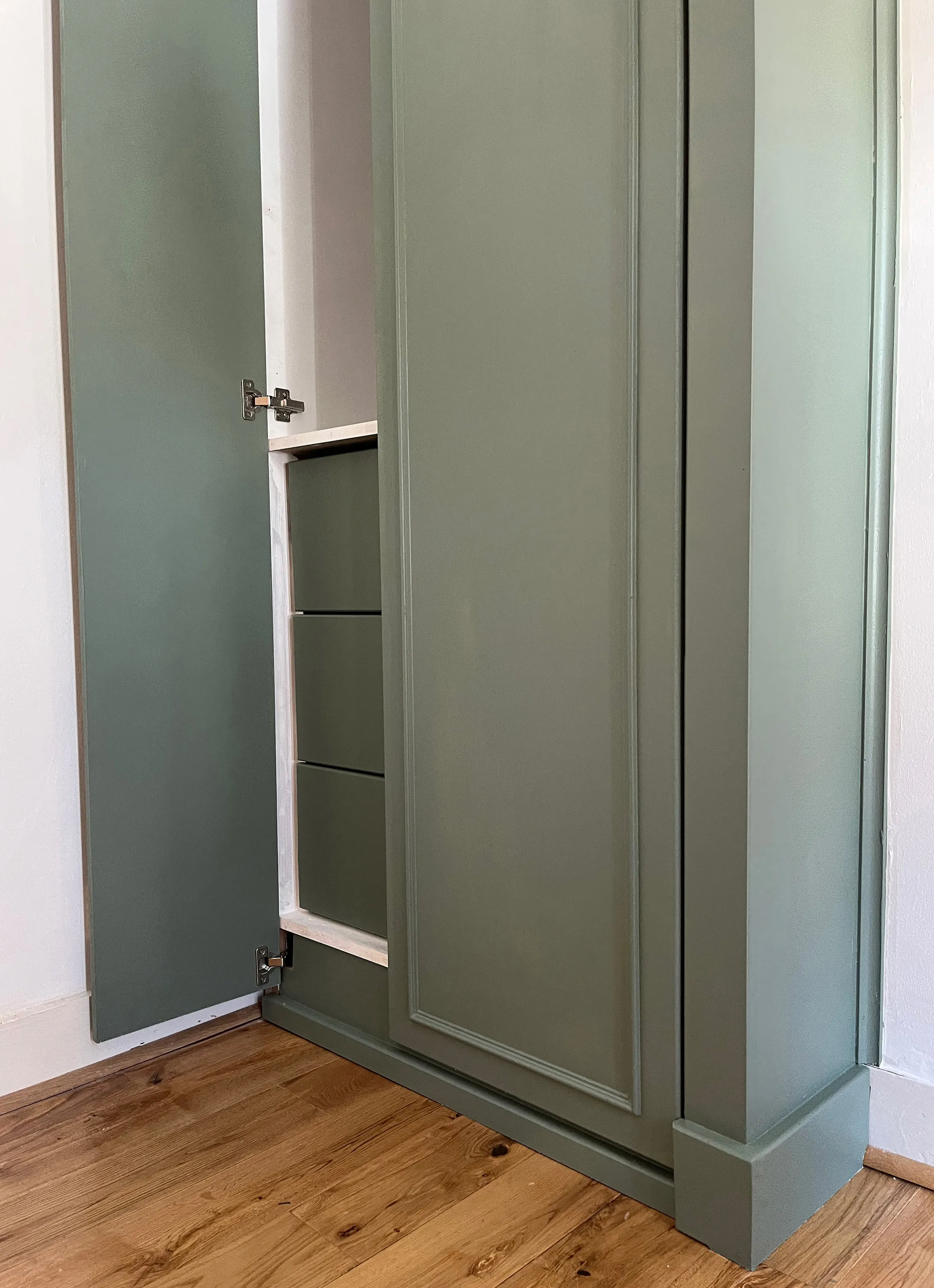 A close up view of the left hand wardrobe with a single smaller door open and the larger door closed